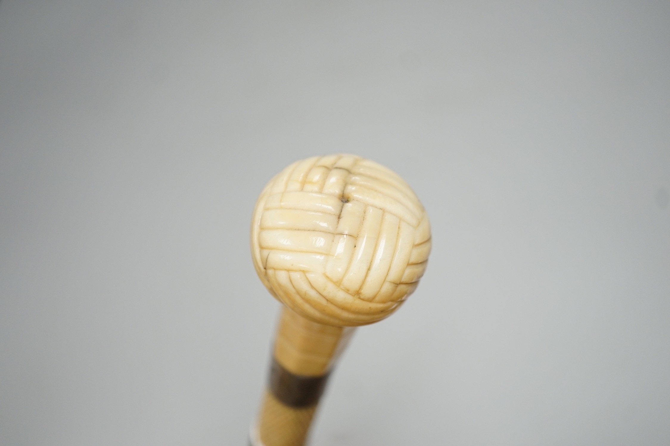 A 19th century scrimshaw whalebone walking cane with white metal mounts, length 69cm